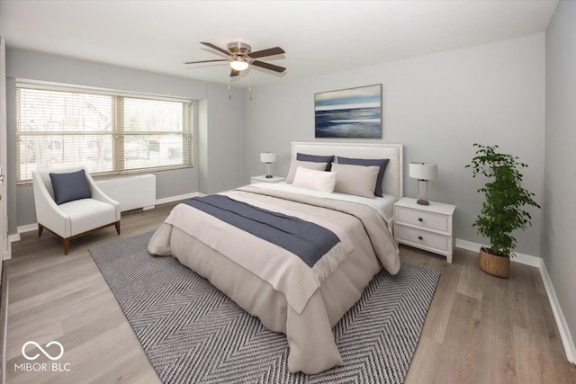 bedroom with radiator, ceiling fan, and light hardwood / wood-style floors