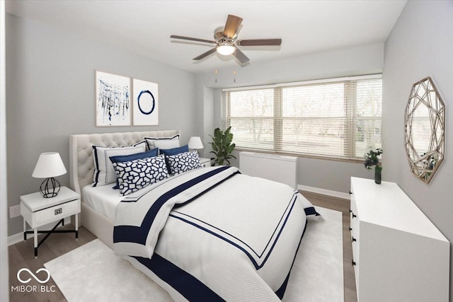 bedroom featuring hardwood / wood-style floors and ceiling fan