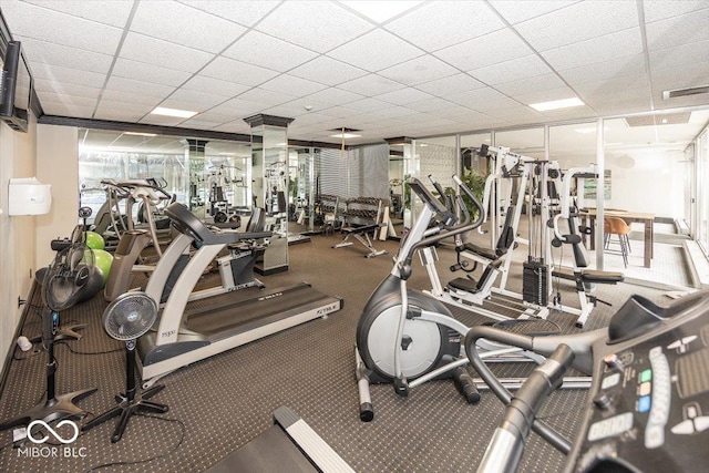 exercise room with carpet floors and a wall of windows