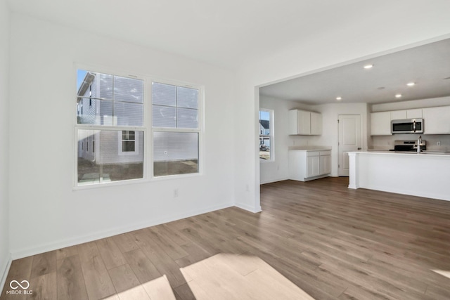 unfurnished living room featuring light wood-type flooring