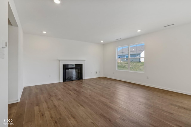 unfurnished living room featuring wood-type flooring