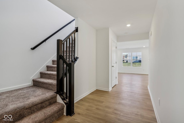 stairway with hardwood / wood-style flooring