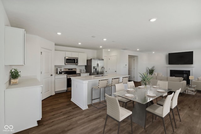 dining area with sink and dark wood-type flooring