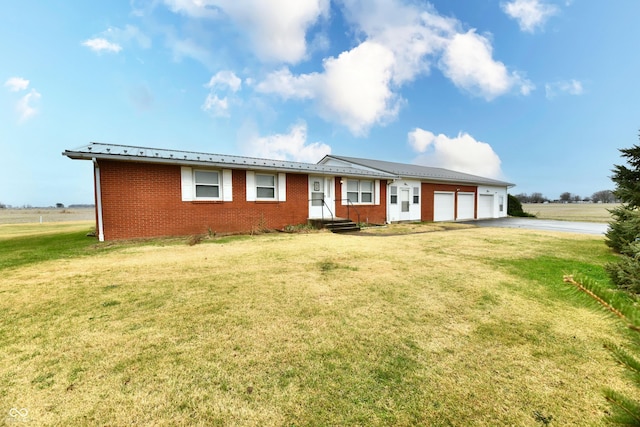 ranch-style house featuring a front lawn and a garage