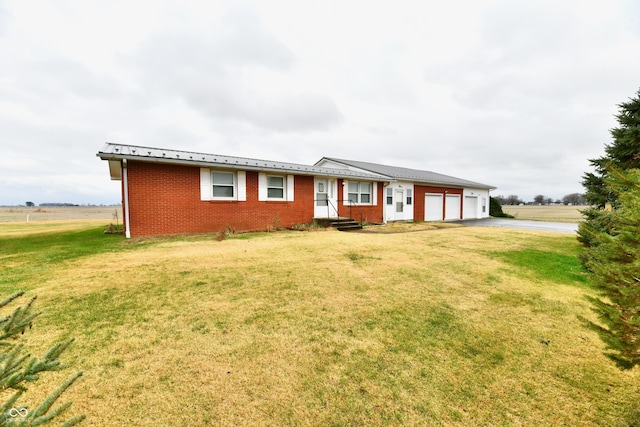 single story home with a garage and a front lawn