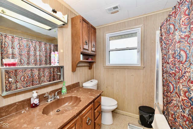 bathroom with a shower with curtain, vanity, toilet, and wood walls