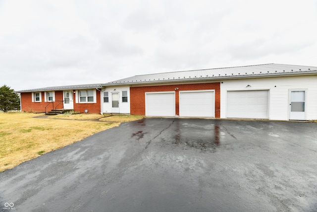 ranch-style house featuring a front lawn and a garage