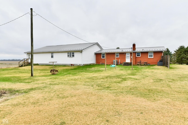 rear view of house with a lawn