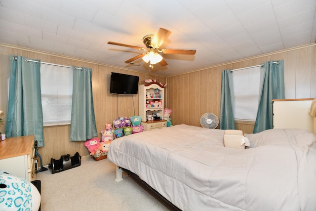 bedroom featuring ceiling fan, carpet floors, and ornamental molding