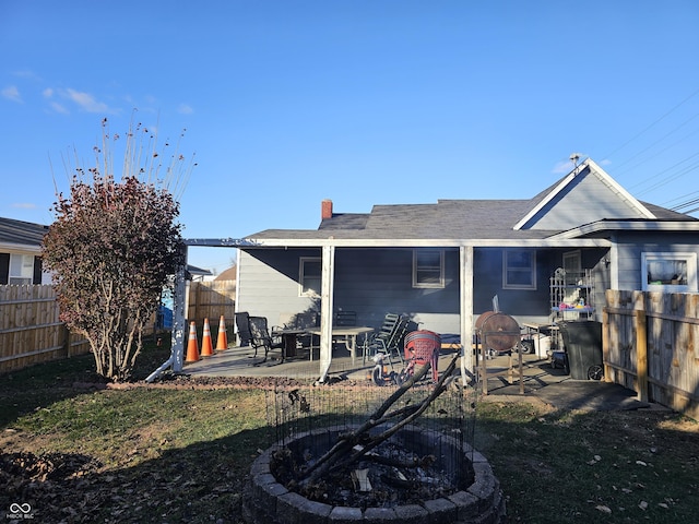 back of property featuring a patio area and a yard