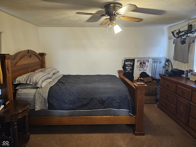 bedroom with ceiling fan and dark carpet