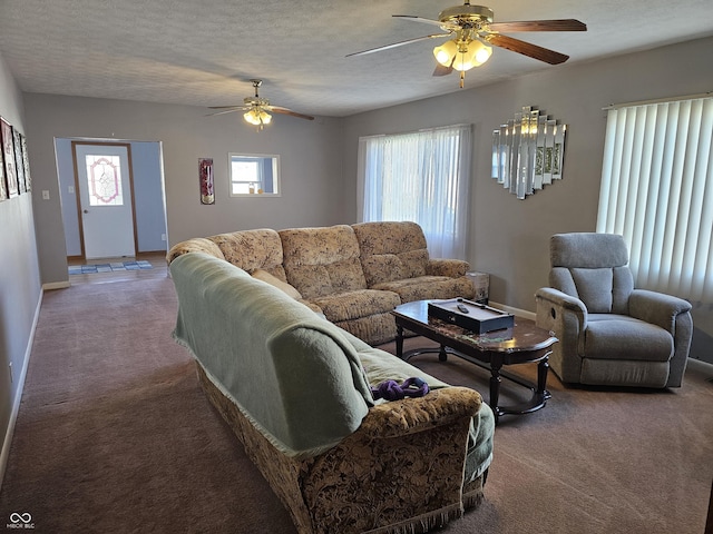 carpeted living room featuring ceiling fan and a textured ceiling