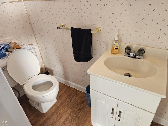 bathroom featuring hardwood / wood-style floors, vanity, and toilet