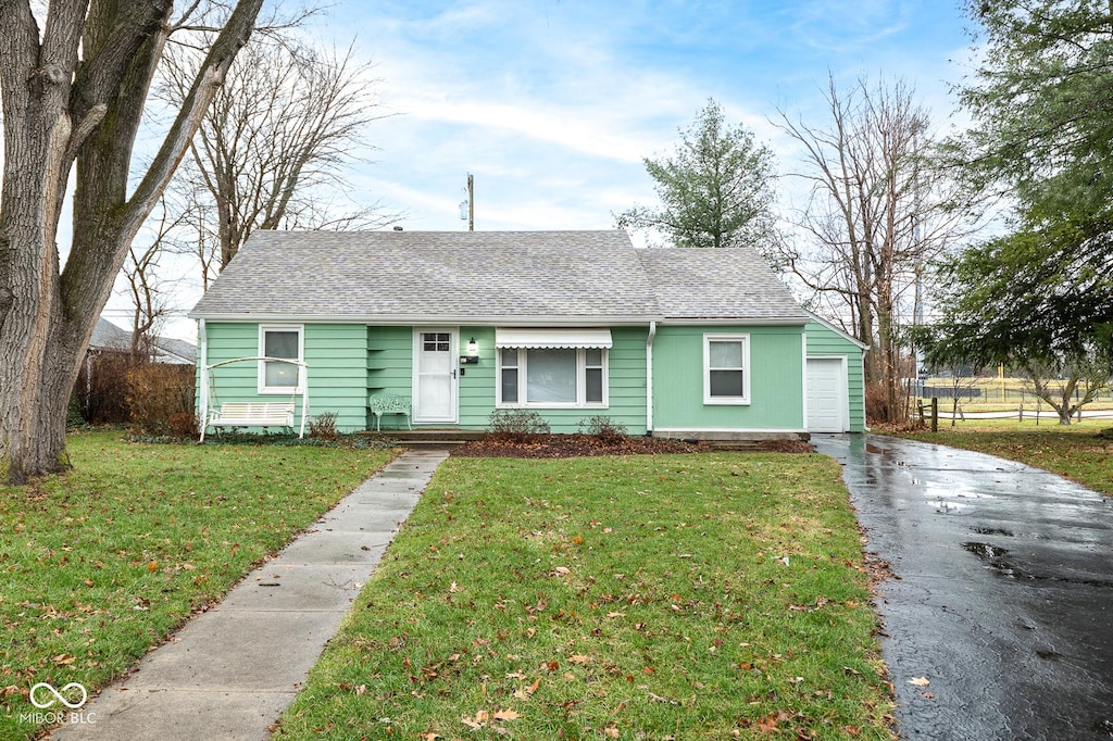 single story home with a garage and a front yard