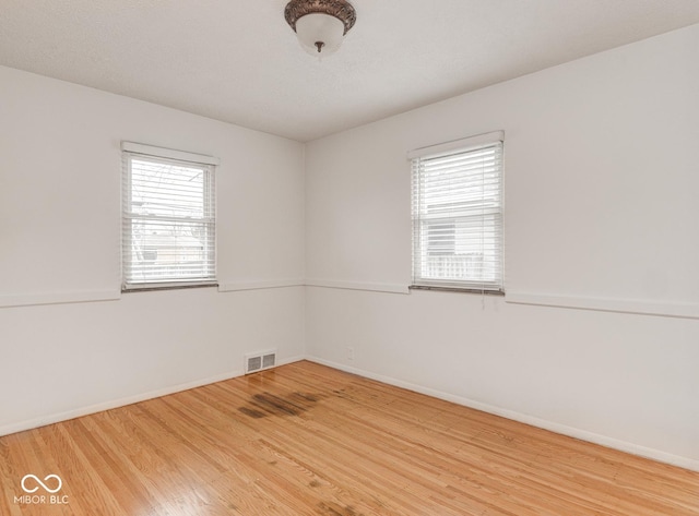 spare room with hardwood / wood-style flooring