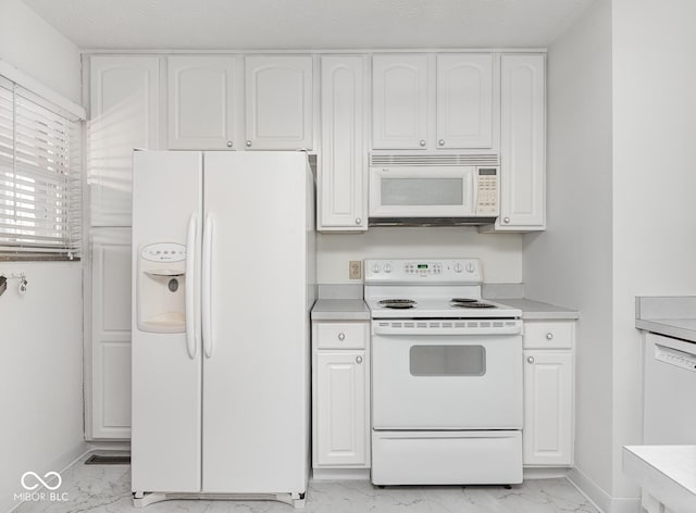 kitchen featuring white cabinets and white appliances