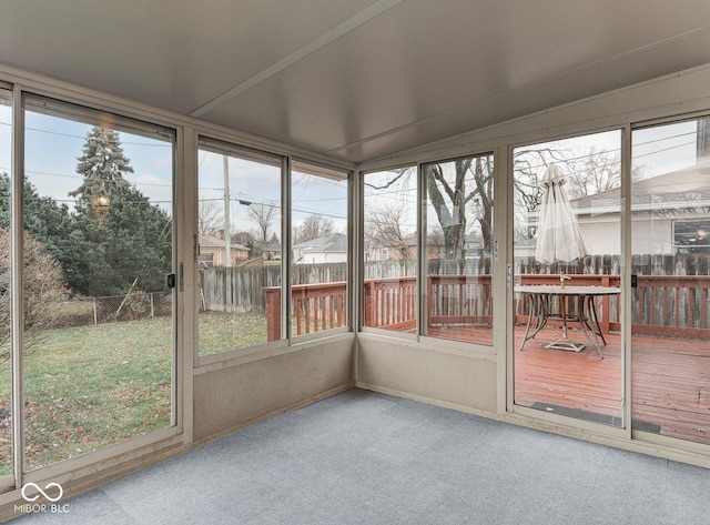 unfurnished sunroom featuring plenty of natural light and lofted ceiling