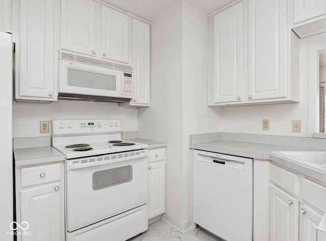 kitchen with white cabinetry and white appliances