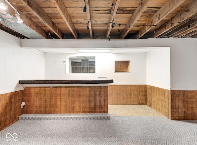 bar with carpet floors and wooden walls