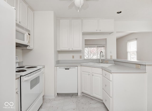 kitchen with white cabinets, white appliances, plenty of natural light, and sink