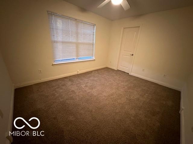 carpeted empty room with ceiling fan