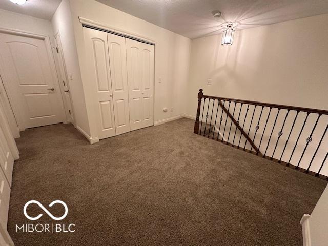 basement with dark carpet