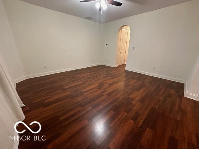 spare room with ceiling fan and dark hardwood / wood-style flooring