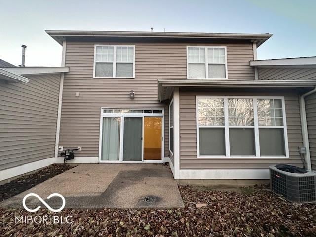 rear view of property featuring a patio and central AC