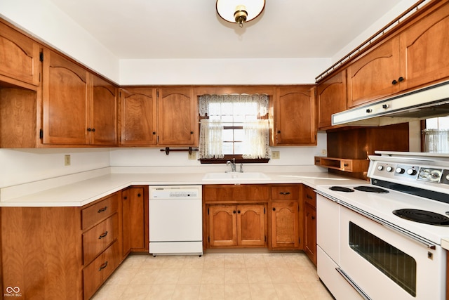 kitchen featuring white appliances and sink