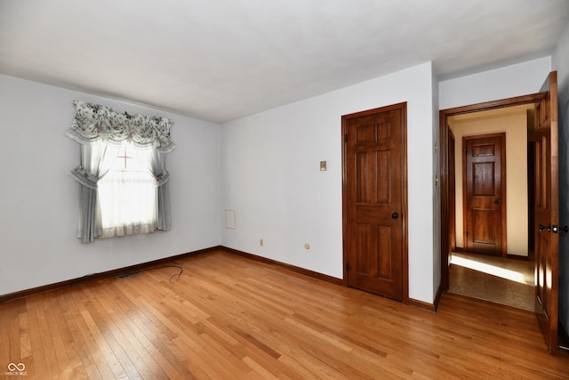 unfurnished room with light hardwood / wood-style floors