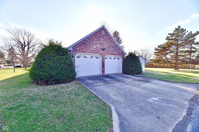 view of side of home with a lawn and a garage