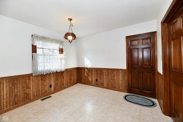 spare room featuring wooden walls