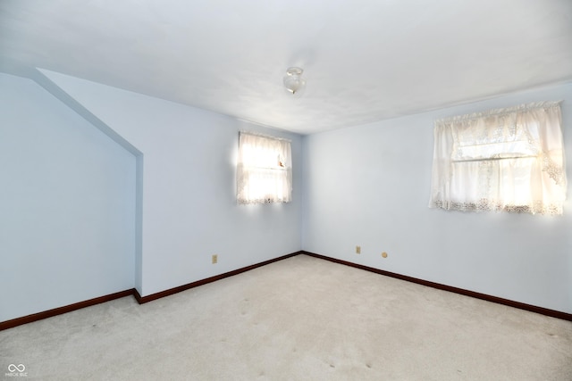 unfurnished room featuring light carpet