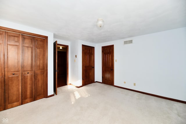 unfurnished bedroom featuring light carpet