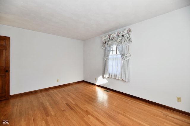 empty room with hardwood / wood-style floors