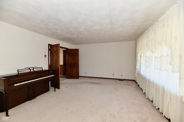 spare room featuring light colored carpet