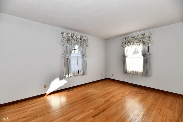 unfurnished room with wood-type flooring