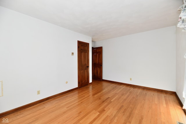 spare room with light hardwood / wood-style flooring