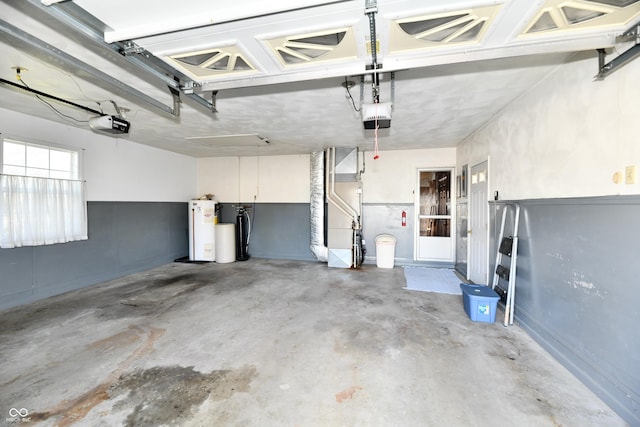 garage with water heater and a garage door opener