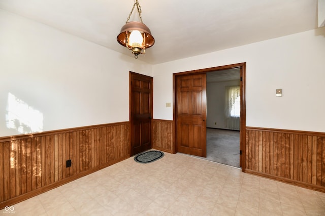 spare room featuring wooden walls