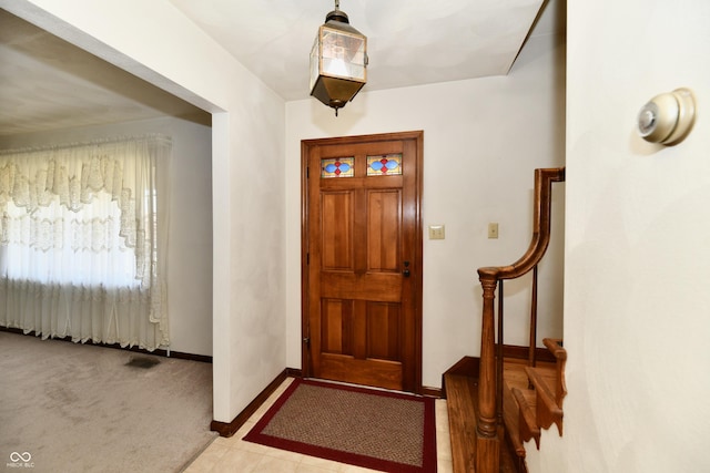 view of carpeted foyer entrance