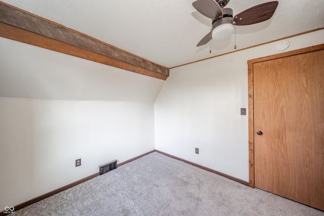 bonus room featuring lofted ceiling with beams, light colored carpet, and ceiling fan