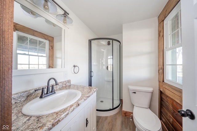 bathroom featuring hardwood / wood-style floors, plenty of natural light, and a shower with door