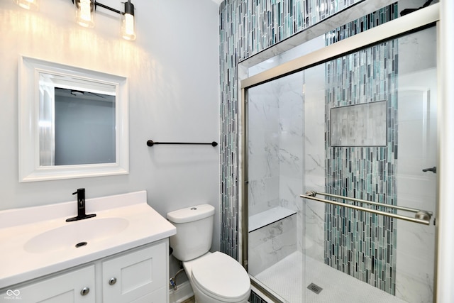 bathroom with vanity, toilet, and walk in shower