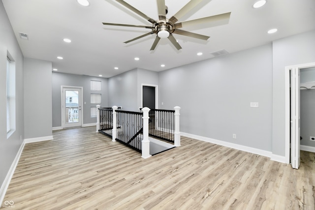 workout area featuring light hardwood / wood-style floors and ceiling fan