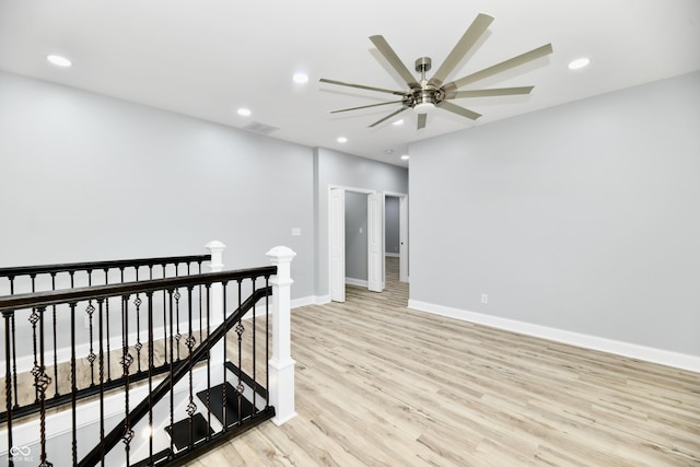 empty room featuring ceiling fan and light wood-type flooring