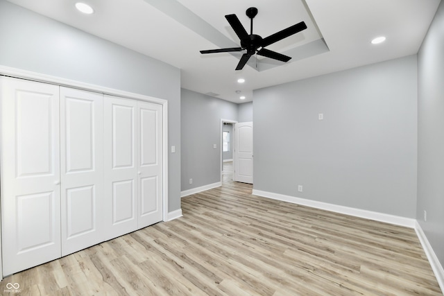 unfurnished bedroom featuring a closet, ceiling fan, and light hardwood / wood-style flooring