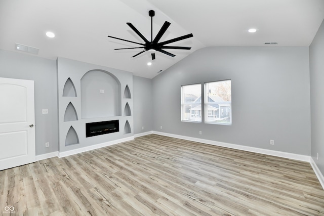 unfurnished living room featuring ceiling fan, light hardwood / wood-style flooring, and vaulted ceiling