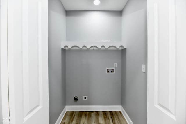 laundry room featuring electric dryer hookup, hookup for a washing machine, and hardwood / wood-style flooring