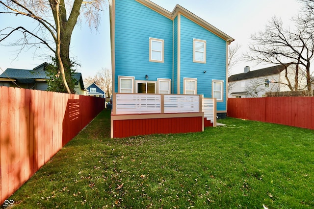 back of house featuring a yard and a deck